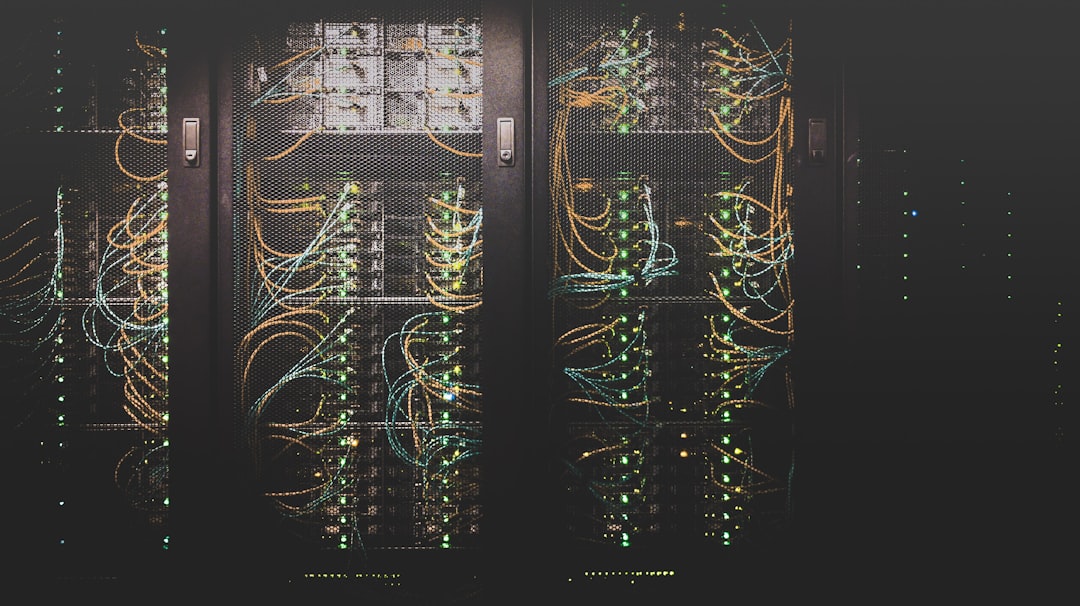 Corredor de servidores com cabos de rede em um centro de dados; imagem ilustrativa da infraestrutura digital.